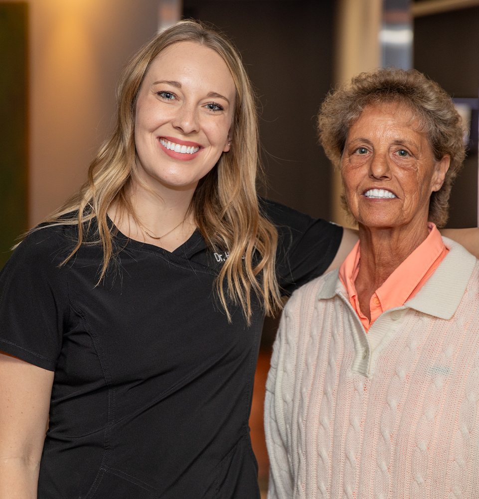 Dr. Heiman and patient smiling in the hallway